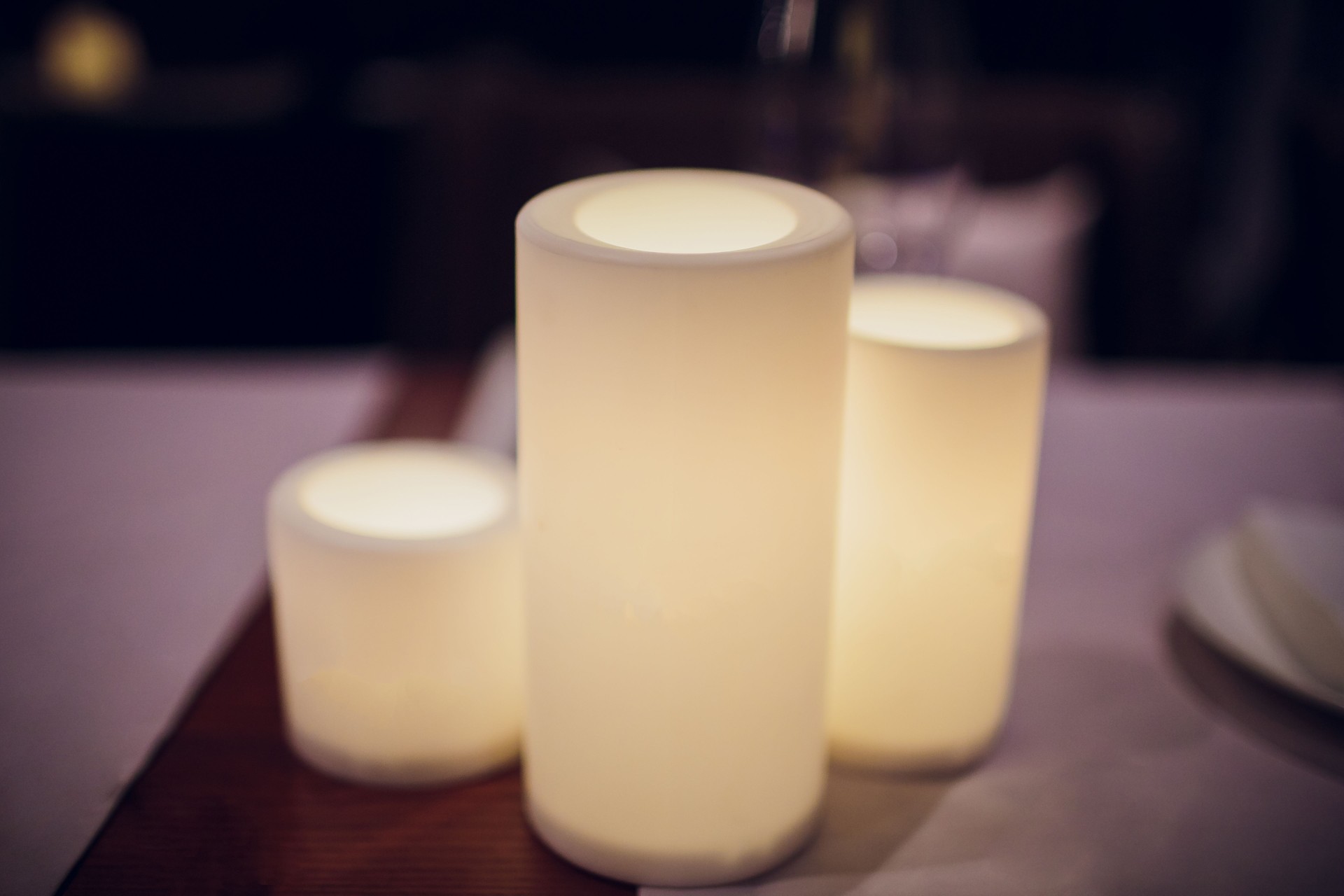 Electric candle on the dinner table Night. Blur background, Focus selected